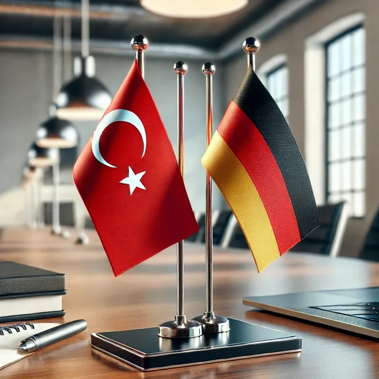 Türkische und deutsche Flaggen auf einem Tisch in einem modernen Büro.