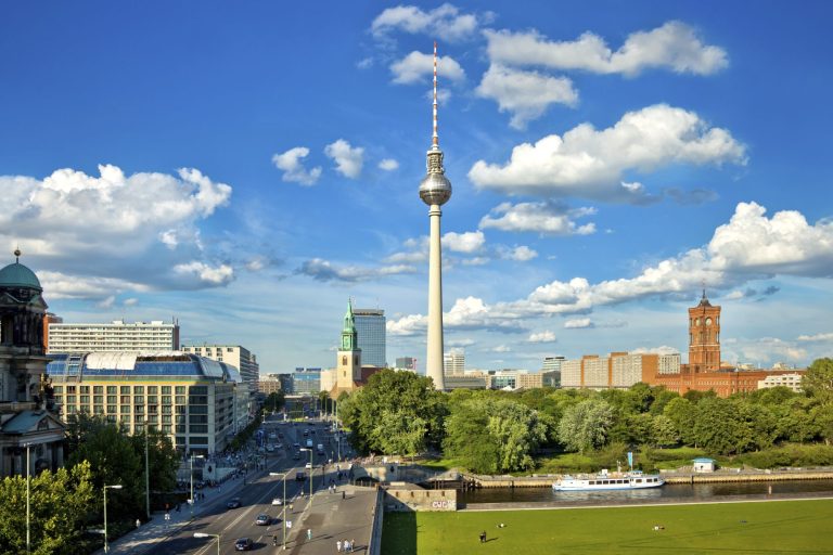 Skyline von Berlin mit dem Fernsehturm und einem klaren blauen Himmel.